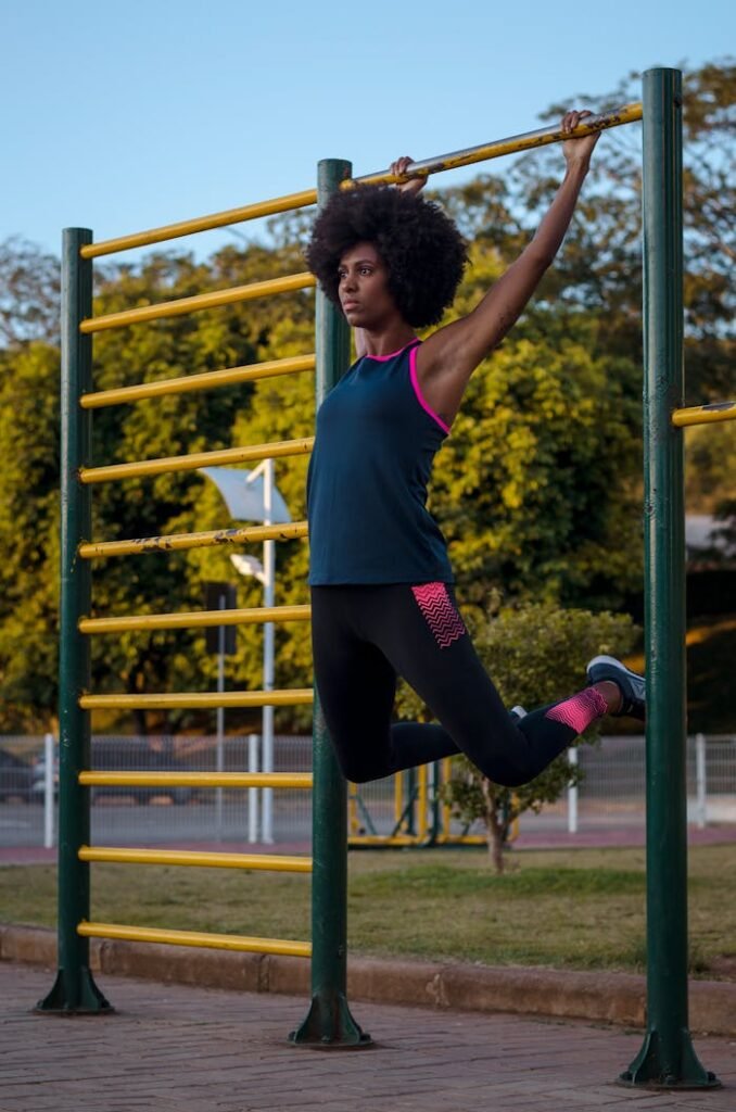 Woman Hanging on Climb Bar on Park